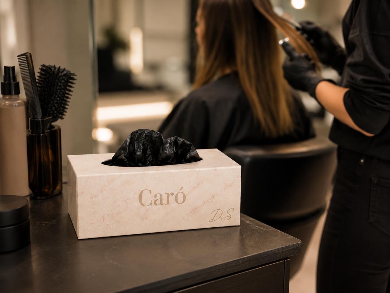 CARÓ glove box beside a stylist working in a salon